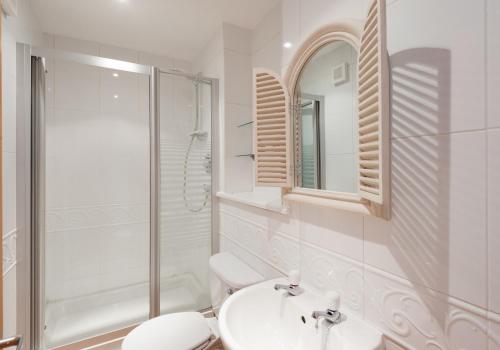 a bathroom with a toilet and a sink and a shower at The Botanist Apartment Edinburgh Old Town 2 Bedroom Lift Parking previously The Parkgate Residence in Edinburgh
