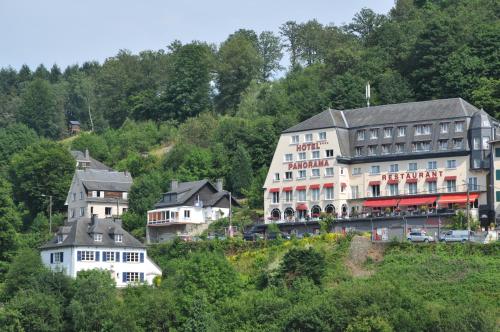 a group of buildings on a hill with trees at Hôtel Panorama - Vue exceptionnelle sur la Semois in Bouillon