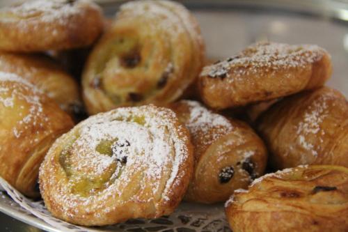 a plate of donuts with powdered sugar on them at Kurparkhotel-Gemünd in Gemünd