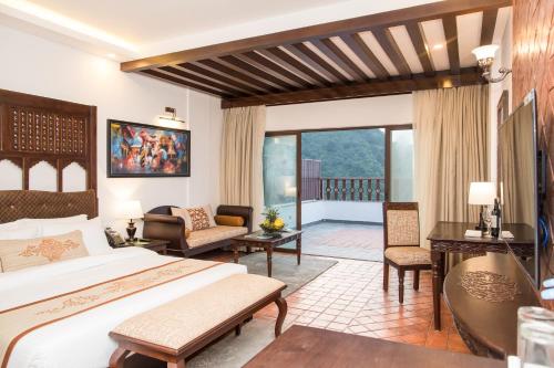 a hotel room with a bed and a balcony at Chandragiri Hills Resort Kathmandu-Luxury in the Clouds in Thānkot