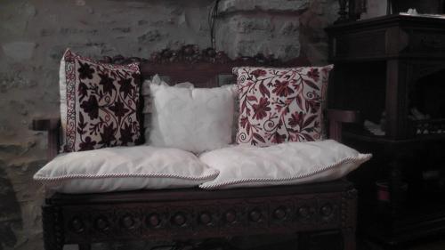 two pillows sitting on top of a wooden chair at The Pounti in Pyrgi