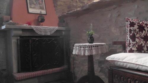 a room with a fireplace and a bed and a lamp at The Pounti in Pyrgi