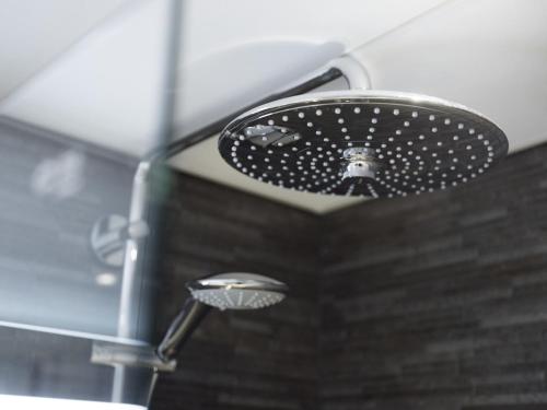 a shower with a shower head in a bathroom at Radisson Blu Hotel Bodø in Bodø