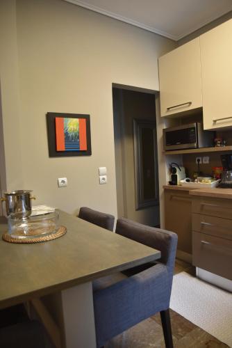 a kitchen with a table and chairs in a room at Amazing Apartment in Athens