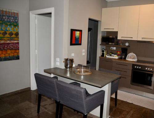 a kitchen with a table and chairs in a kitchen at Amazing Apartment in Athens