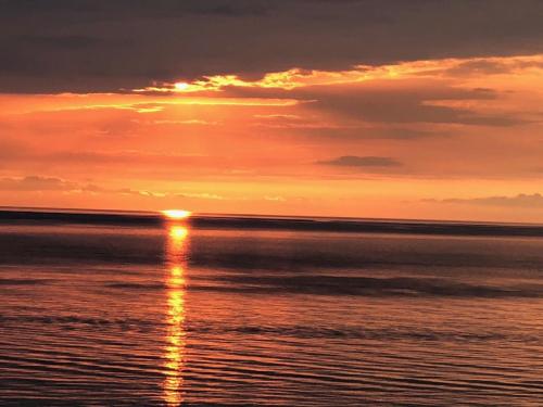 a sunset over the ocean with the sun in the sky at Beachfront Luxury Apartments Elizabeth, Pomorie in Pomorie