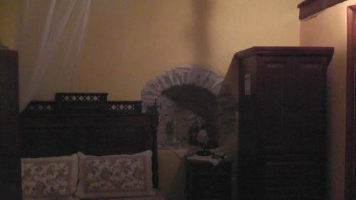 a bedroom with a bed and a dresser and a mirror at The Pounti in Pyrgi