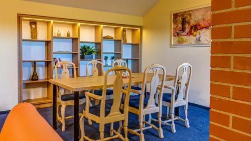 a dining room with a table and chairs at Hotel Traumblick in Oberhof