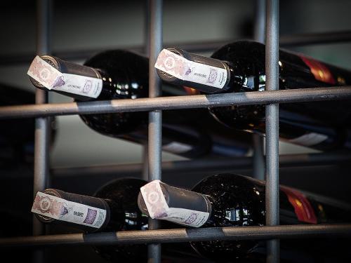 a bunch of bottles of wine on a rack at The Loft Hotel Adults Only in Kraków