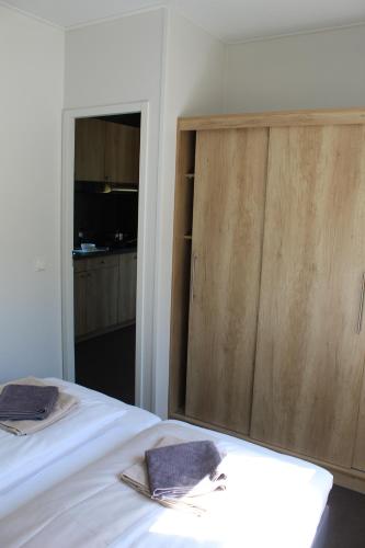 a bedroom with a bed and a wooden cabinet at Chaletpark Petzen in Feistritz ob Bleiburg