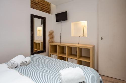 a bedroom with a bed with towels on it at Charming flat in Lisbon's center! in Lisbon