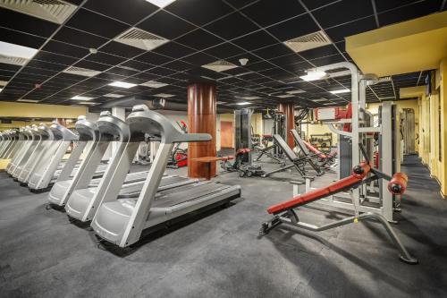 a gym with several rows of tread machines at Grand Royal Hotel in Poznań