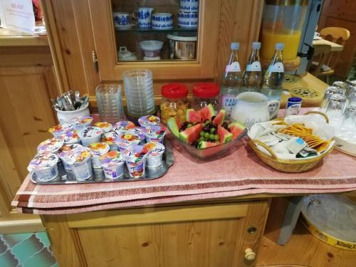 a counter top with a bunch of food and drinks at Hotel zur Post limburg Bad camberg in Hünfelden