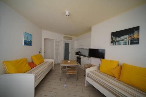 a living room with two couches and a table at Holiday home Isola Rossa in Isola Rossa