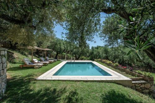 a swimming pool in the middle of a yard at Leeda's Village in Lithakia