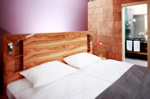 a bed with two white pillows in a bedroom at Hapimag Resort Tonda in Montaione