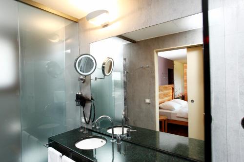 a bathroom with a sink and a mirror at Hapimag Resort Tonda in Montaione