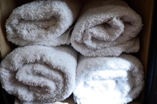 a pile of white towels stacked on top of each other at Hotel Niku in Tirana