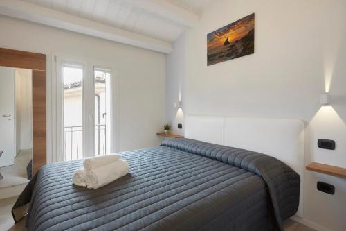 a bedroom with a bed with a pillow on it at Affittacamere Somnium in Sirolo