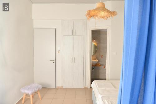 a bathroom with a bed and a blue curtain at SEA VIEW ROOMS Afissos in Afissos