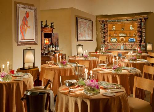 a dining room filled with tables and chairs with candles at Bio Hotel Raphael - Relais & Châteaux in Rome