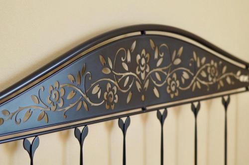 a black metal railing with gold flowers on it at L'Antico Borgo B&B in Levanto