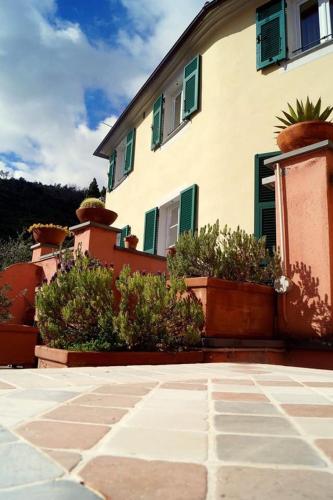 a building with potted plants in front of it at L'Antico Borgo B&B in Levanto