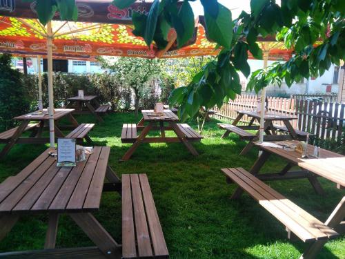 a group of picnic tables sitting in the grass at Penzion Dřevěnka in Osečná