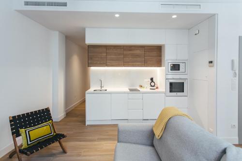 a living room with a couch and a kitchen at The Lucky Flats - Poeta Quintana in Alicante