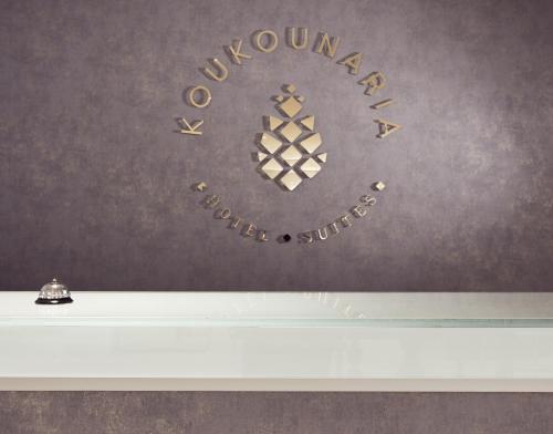 a sign on a wall with the words ovationxual studio at Koukounaria Hotel & Suites in Alykes
