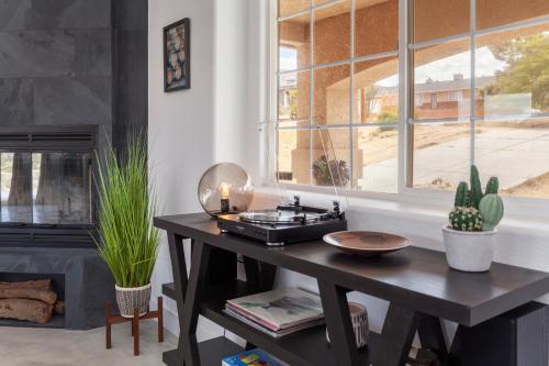 a table in a living room with a window at The Cherokee House in Joshua Tree in Joshua Tree
