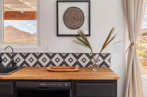 a kitchen with a counter with a cutting board on it at The Cherokee House in Joshua Tree in Joshua Tree
