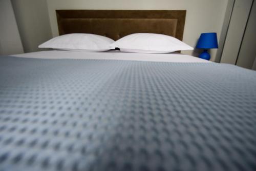 a close up of a bed with two pillows at Hotel Niku in Tirana