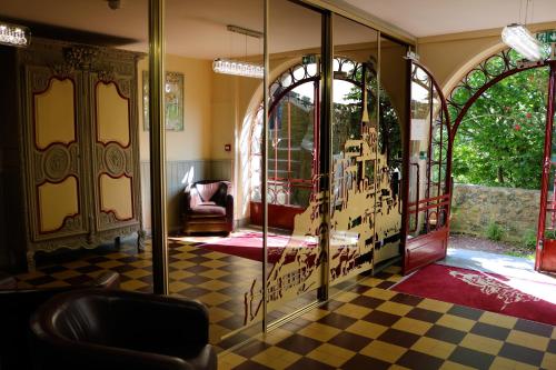 a room with a glass door with a checkered floor at La Mère Poulard in Le Mont Saint Michel