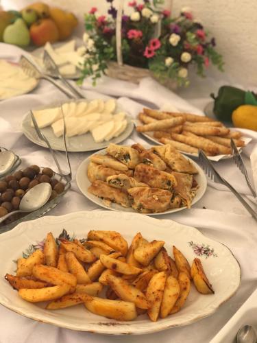 a table with plates of food on top at Halikarnas Pansiyon in Bodrum City