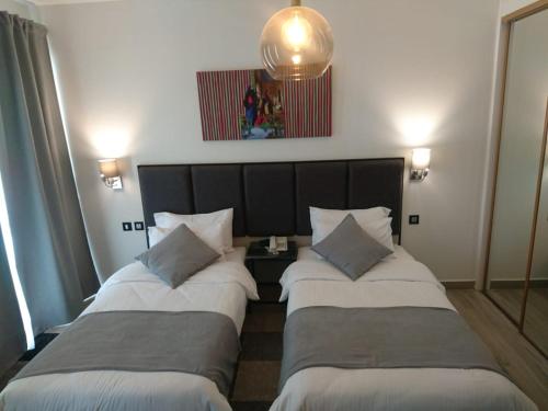 Ein Bett oder Betten in einem Zimmer der Unterkunft The Conroy Boutique Hotel