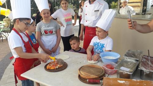 a group of children in chefs hats preparing food at Adriatik Hotel, BW Premier Collection in Durrës