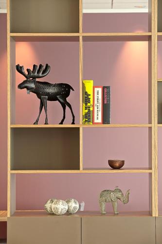a shelf with a statue of a deer and an elephant at Hérað - Berjaya Iceland Hotels in Egilsstadir