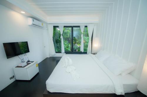 Säng eller sängar i ett rum på Trat 101 Hotel - SHA Certified