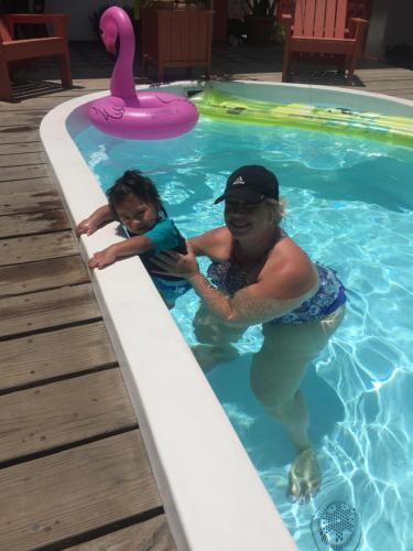 a woman and a child in a swimming pool at Ambergris Sunset Hotel in San Pedro