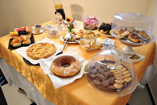 a table filled with different types of pastries and cookies at Hotel Columbia in Palermo