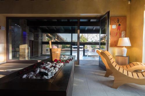 a living room with a fireplace and a couch at Colle Indaco Wine Resort & Spa in Ortezzano