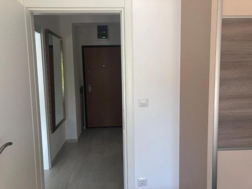 a hallway with a door leading into a room at Apartments Bane in Herceg-Novi