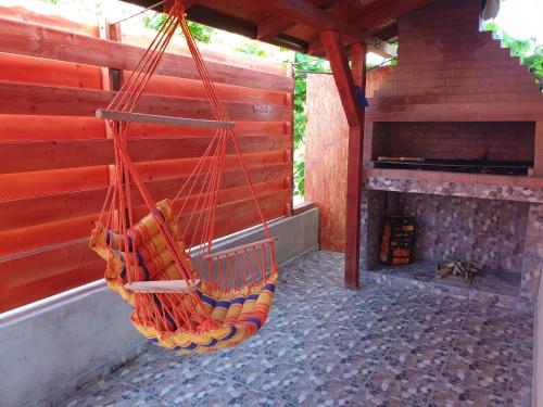 a hammock hanging from a building with a fireplace at ingrid in Mangalia