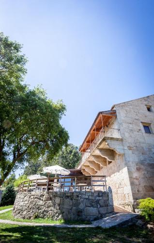 a stone building with a staircase on the side of it at Casa Rural Abadia Eiras in Rosal