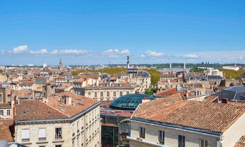 a view of a city with buildings and roofs at Hotel Konti Bordeaux by HappyCulture in Bordeaux