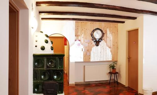 a hallway with a clock on the wall at Aparthotel Pan Haus in Bad Ischl