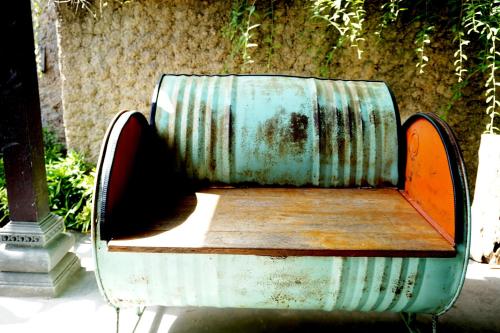 a metal bench sitting on the side of a sidewalk at Louto Dmell Villa & Guesthouse in Sanur