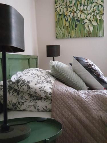 a bedroom with a bed with pillows and a lamp at Majątek Morgi in Suchowola