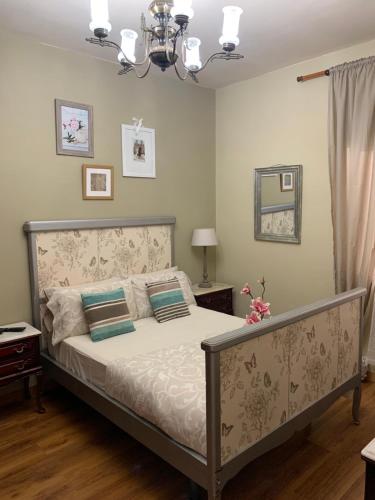 a bedroom with a bed and a chandelier at Dream Flat in Santa Cruz de Tenerife